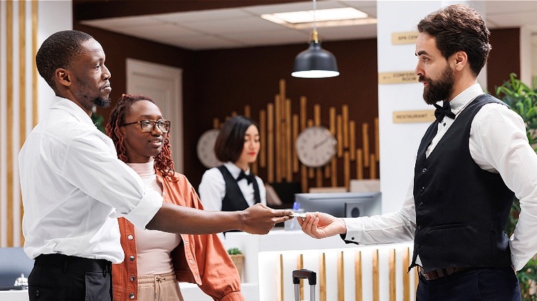 Hotel staff receiving cash tip