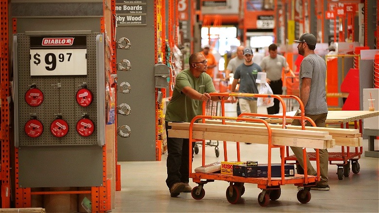 Customers shopping Home Depot lumber