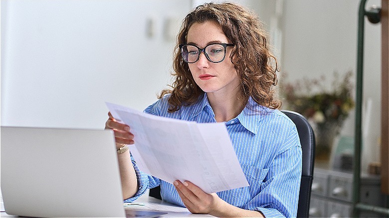 Person reviewing document at computer