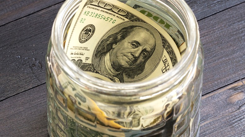 $100 bills in money jar