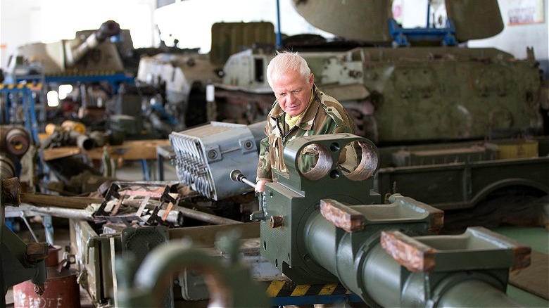 Person inspecting tanks being built