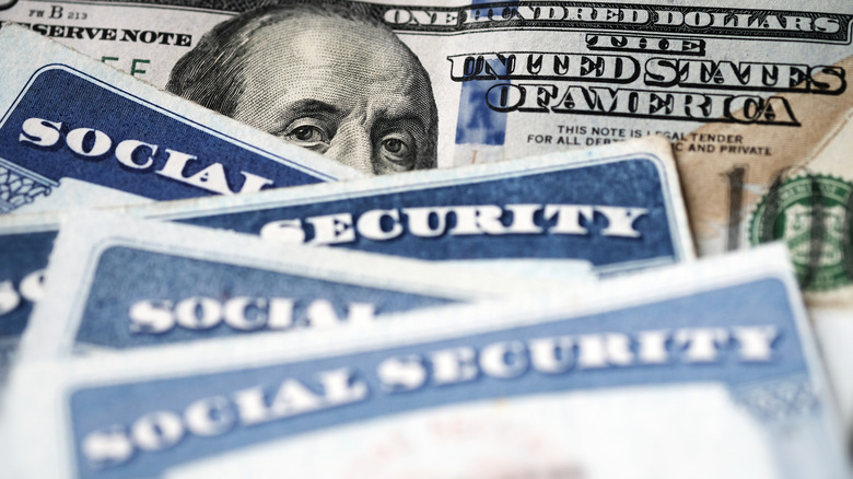 Social Security cards on a $100 bill