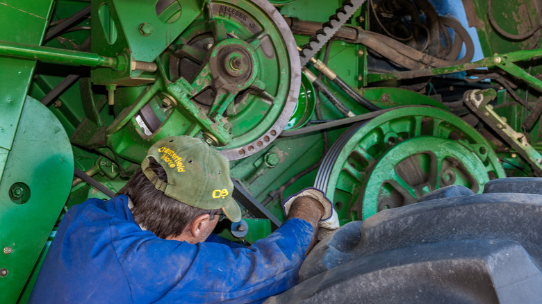 mechanic fixing a tractor