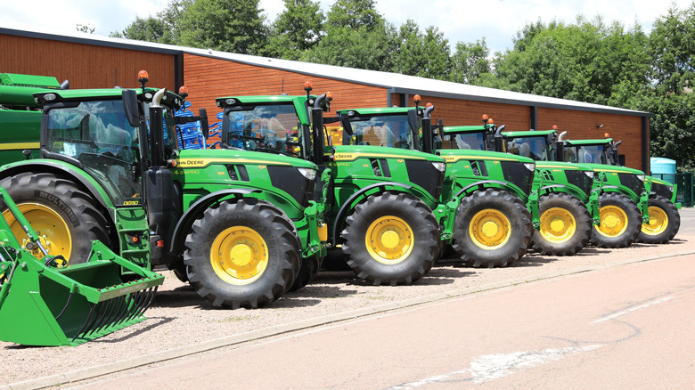 a row of John Deere tractors