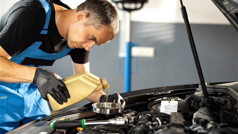 Mechanic changing engine oil