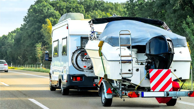 RV hauling boat down highway