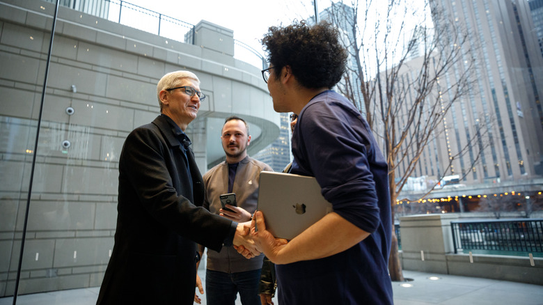 Apple CEO Tim Cook shaking an employee's hand