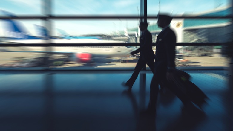 Blurred pilots walking in airport