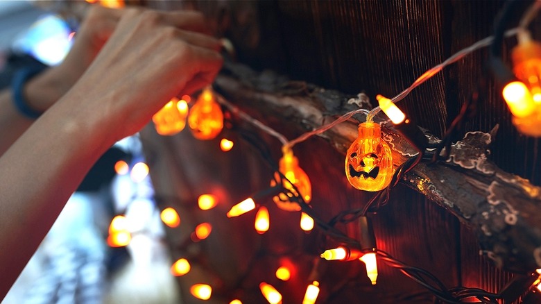 Person hanging Halloween light string