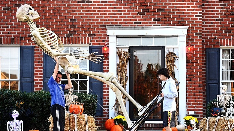 People setting up giant skeleton