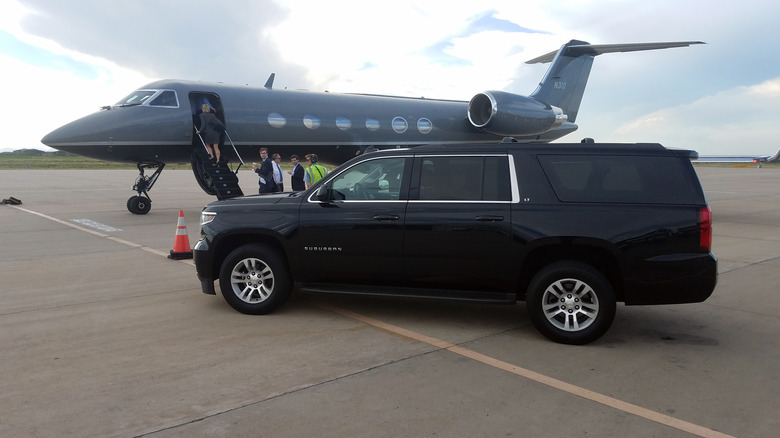 Car next to private jet