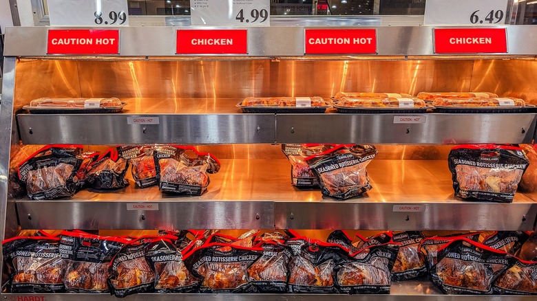 Bagged Costco chickens in their warming station shelves.