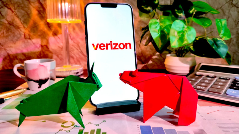 A phone screen displaying the Verizon logo on a desk