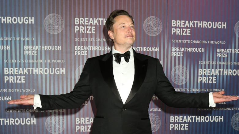 Elon Musk posing for photo in a tuxedo