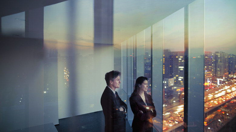 corporate executives standing in skyscraper office