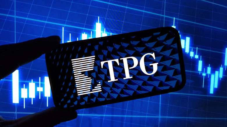 TPG on phone in front of stock data