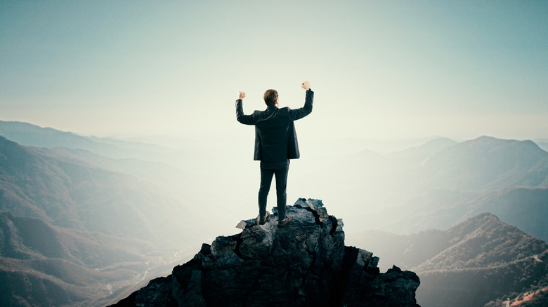 Triumphant man on mountain top