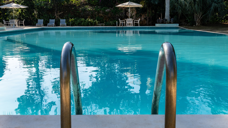 Community pool with tables and umbrellas