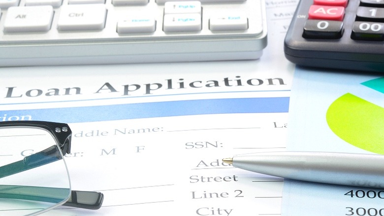 Loan application on cluttered desk