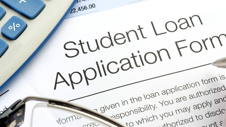 Student signing a loan application