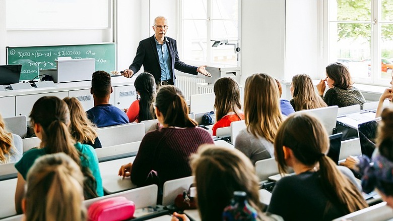 Professor gives lecture to students in a well-lit classroom