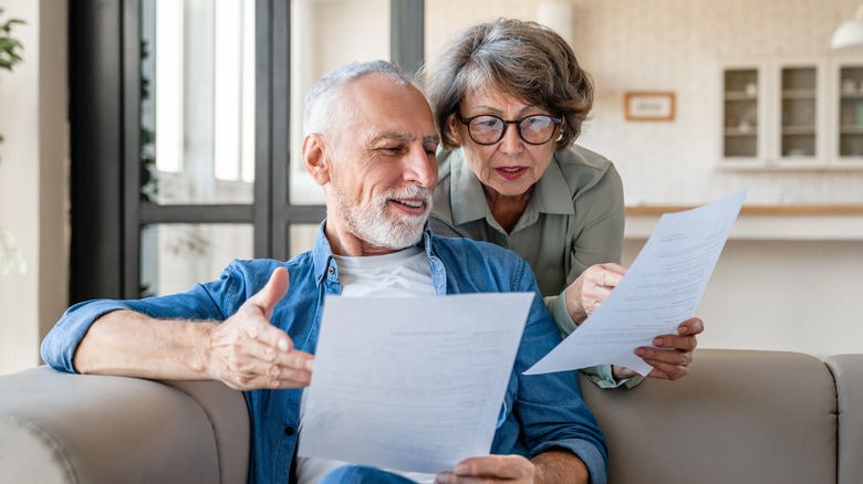 elderly couple reviewing financial papers