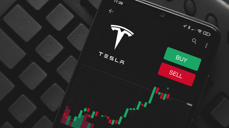 smartphone displaying app to trade Tesla stock