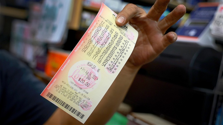 Person holding Mega Millions ticket