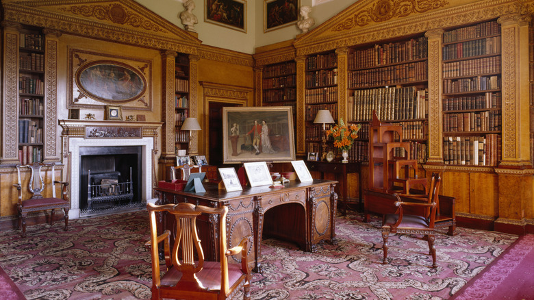 A home library decorated in fine brown furniture from Chippendale.