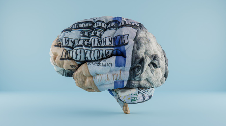 brain with $100 bill graphic superimposed