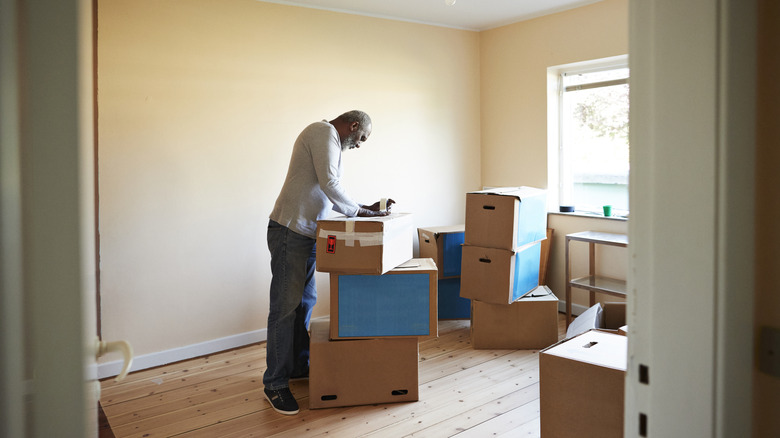 Older man packing boxes to move