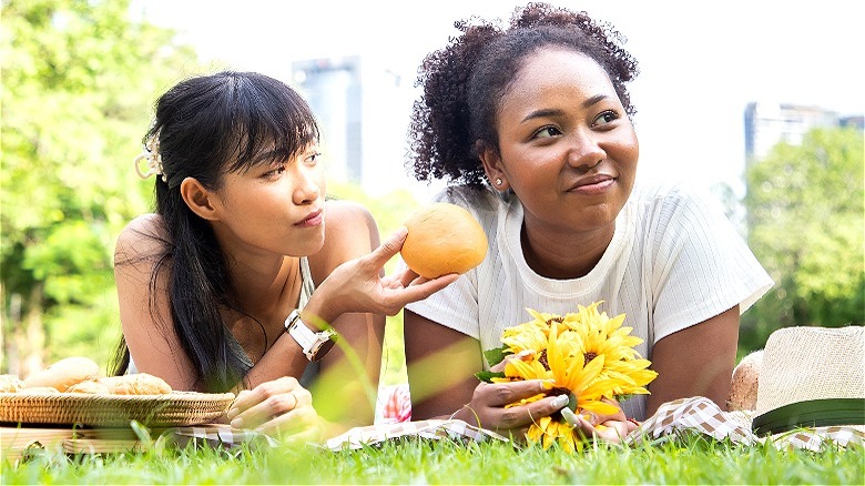 Two people enjoying picnic outdoors