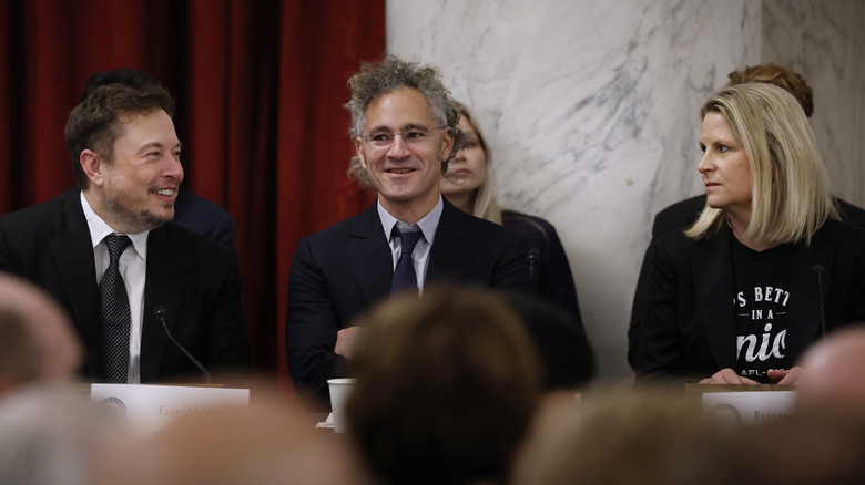 Palantir's CEO standing with other technology executives