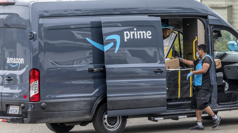 A man loading an Amazon delivery truck