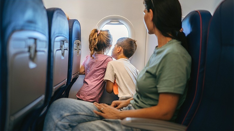 Children with parent in airplane
