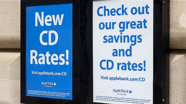 An exterior bank sign offers savings and CD rates