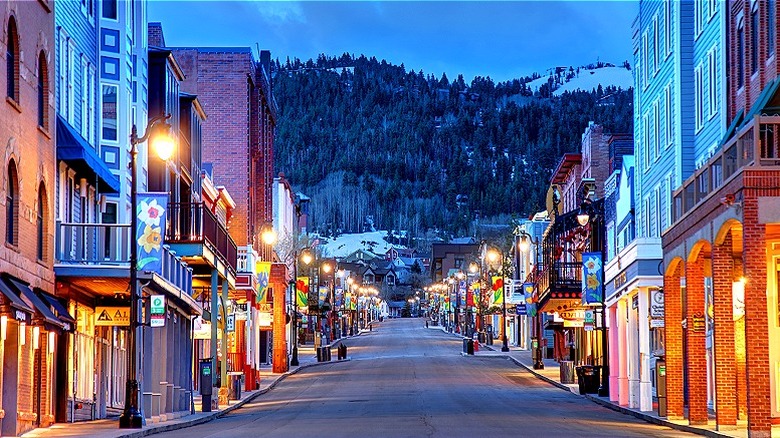 View of an illuminated, empty street in the evening in Park City, Utah