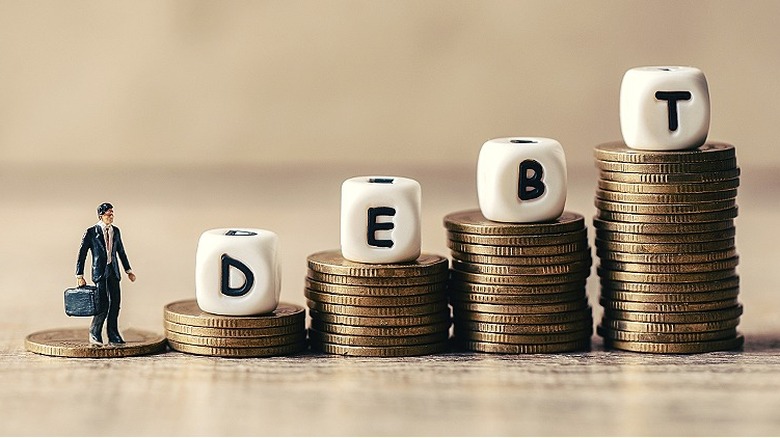 "DEBT" spelled on piles of coins