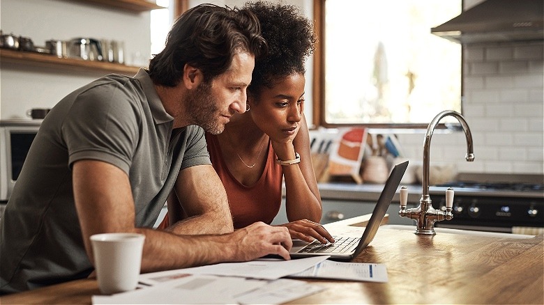 Couple reviewing financials on computer