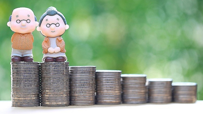 Retiree figurines standing on coins