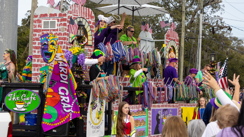 Float Riders in Mardi Gras Costumes Having Fun