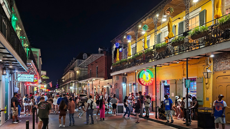 People walking along Bourbon Street in the French Quarter