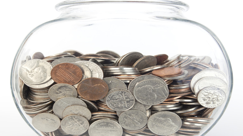 A fishbowl full of U.S. coins.