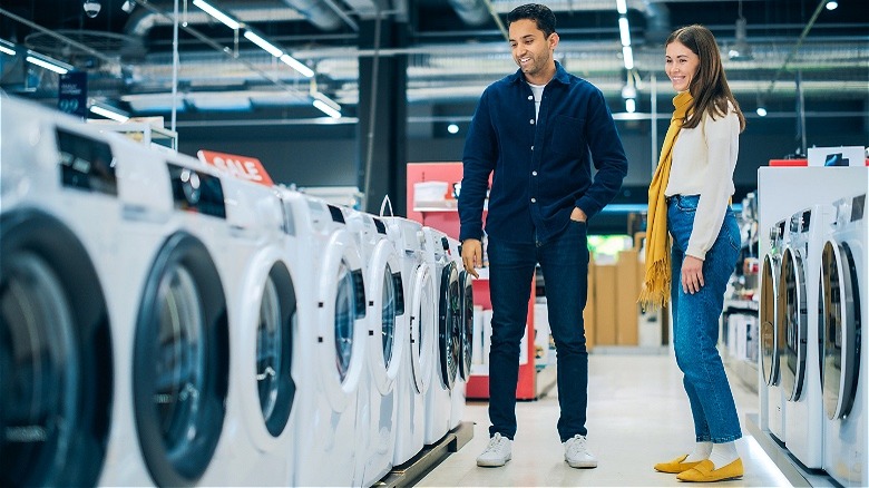 Couple shopping for washing machine