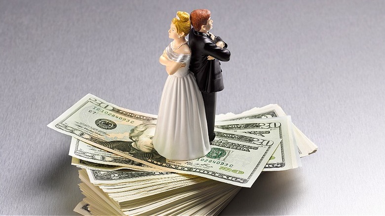 Married figurines on $20 stack