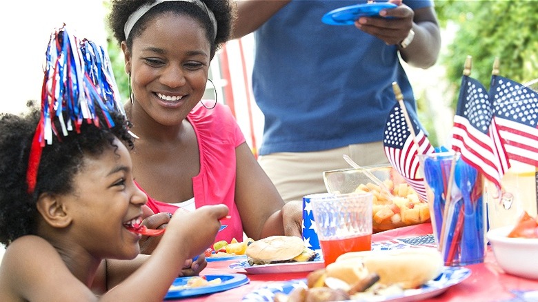 Family enjoying patriotic barbecue