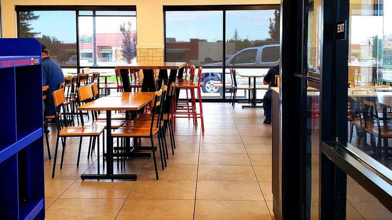 Two customers sit inside a Wendy's restaurant