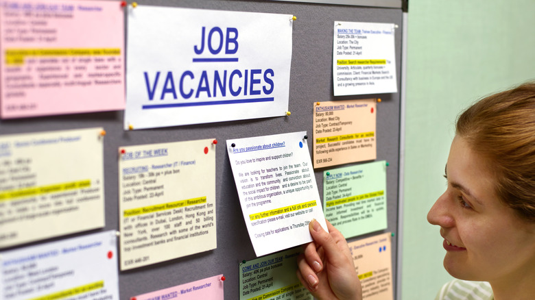 woman looking at job vacancy board