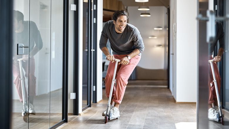 riding a scooter in office