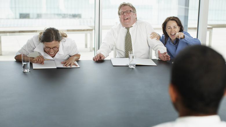 interviewers laughing at person